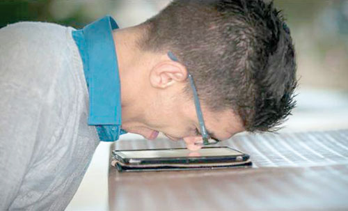 Moutasem Billah Abu Mahfouz demonstrates his typing technique using his nose (Photo by Mervat Al Nouri)