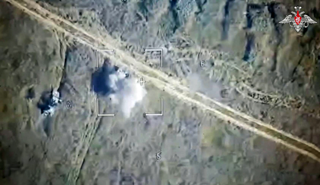 An image taken from a handout footage released by the Russian Defence Ministry on August 6, 2024, shows a Russian drone attack on Ukrainian armoured vehicles outside the town of Sudzha, Kursk Region (AFP photo)