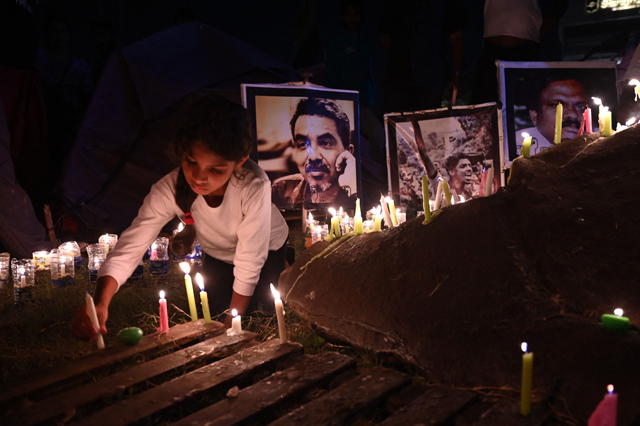 People hold a candlelight vigil for the victims and injured demonstrators during anti-government protests in Colombo on Saturday (AFP photo)