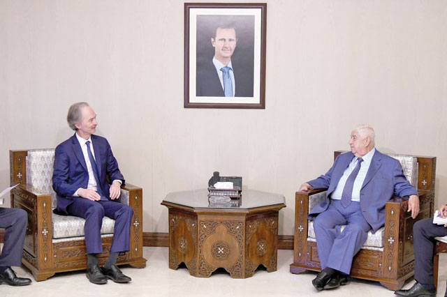 This handout photo released by the official Syrian Arab News Agency on Wednesday shows United Nations special envoy to Syria Geir Pedersen (left) meeting with Syrian Foreign Minister Walid Mouallem in the Syrian capital Damascus (AFP photo)