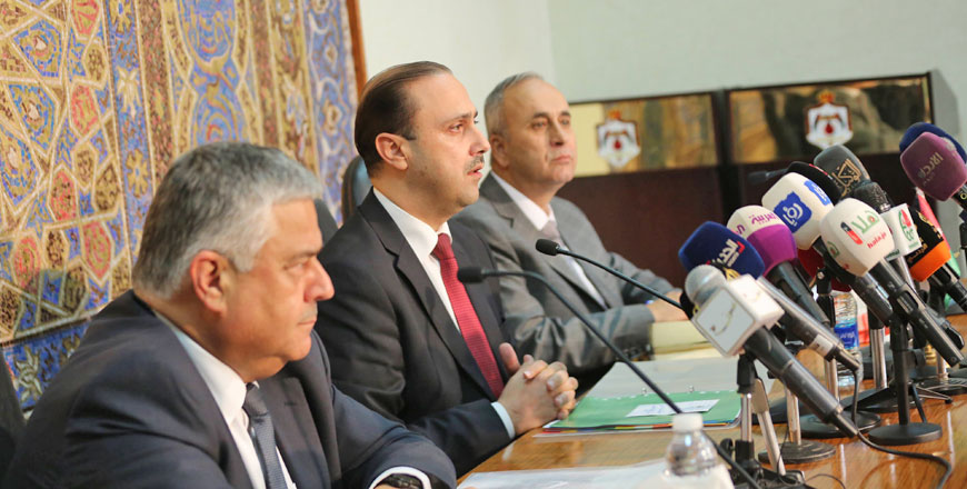 Minister of State for Media Affairs Mohammad Momani (centre) and Finance Minister Omar Malhas (left) speak to reporters on an amended Income Tax Law drafted by the government in Amman on Monday (Petra photo)