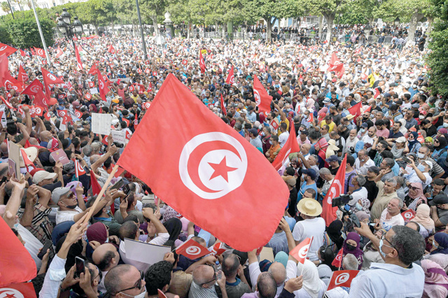 Demonstrators chant slogans during a protest in Tunisia's capital Tunis on Sunday, against President Kais Saied's recent steps to tighten his grip on power. Saied had on July 25 sacked prime minister Hichem Mechichi, suspended parliament and granted himself judicial powers (AFP photo)