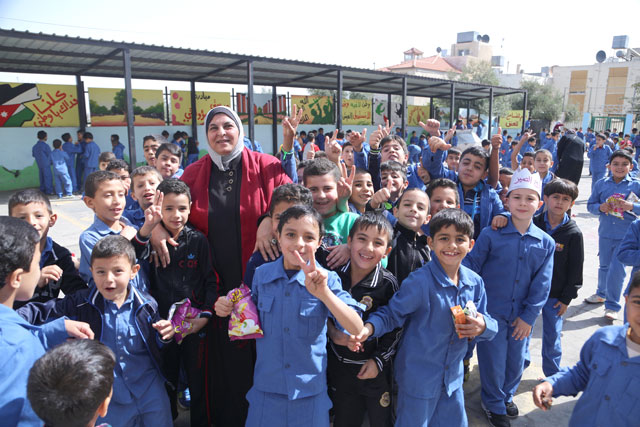 Naifeh Louzi poses for a group photo with her students of Saied Ala’a Eddin public school in Abu Nusair recently  (Photo courtesy of UNICEF)
