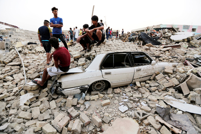 People gather at the site of an explosion in Baghdad's Sadr City district, Iraq, on Thursday (Reuters photo)