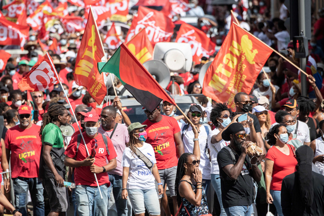 Demonstrators take part in a rally in Fort-de-France, on the French Caribbean island of Martinique, on Monday, as part of a general strike called by unions to protest against measures to curb the spread of COVID-19, and labour and social issues (AFP photo)