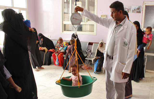 A displaced Yemeni child from the city of Hodeida is weighed at a clinic in the northern district of Yemen’s Hajjah province on Monday (AFP photo)