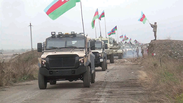 This handout photo taken and released by the defence ministry of Azerbaijan on Friday shows military vehicles running along a road as Azerbaijan army units enter the Aghdam region of Nagorno-Karabakh (AFP photo)