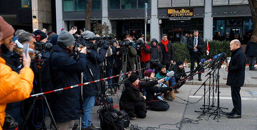 German Chancellor Olaf Scholz (right) gives a press statement in front of journalists at the scene where a car drove into a crowd in Munich, southern Germany, on Saturday (AFP photo)