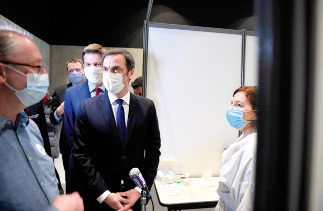 French Health Minister Olivier Veran (centre), flanked by mayor of Nancy Mathieu Klein (centre left), visits a vaccination centre at Jean Prouve Convention Centre in Nancy, eastern France, on Tuesday (AFP photo)