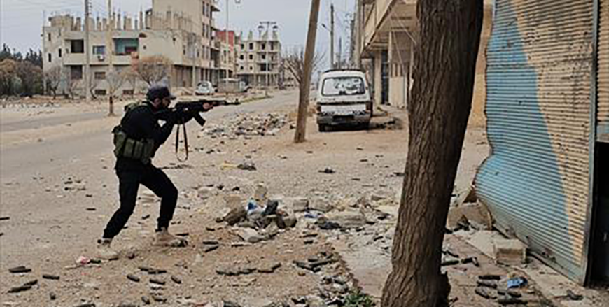 A member of Syria's new authorities security forces fires his weapon in Sanamayn, in the southern province of Daraa, during a reported large scale military campaign on March 5, 2025  (AFP photo)