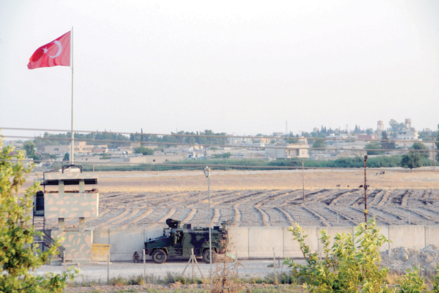 A Turkish military truck patrols next to a Turkish national flag hoisted at the border with Syria on Wednesday, in Akcakale, in Sanliurfa, southeastern Turkey (AFP photo)