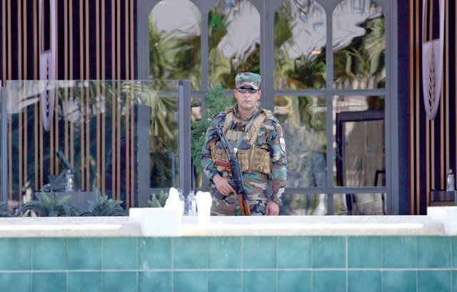 A member of the Iraqi Kurdish security stands guard outside the restaurant where two people were shot dead in Erbil, the capital of northern Iraq's Kurdish autonomous region, on Wednesday (AFP photo)