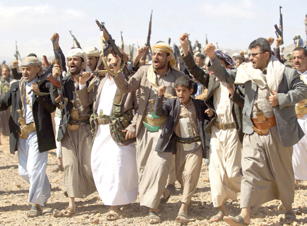 Armed Yemeni men raise their weapons as they gather near the capital Sanaa to show their support to the Shiite Houthi movement against the Saudi-led intervention on Thursday (AFP photo)