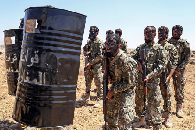 Turkish-backed Syrian fighters attend a military exercise near the rebel-held town of Al Rai in the north of Aleppo province along the border with Turkey on Wednesday (AFP photo)