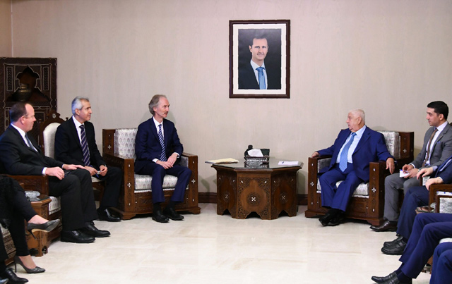 This handout photo released by the official Syrian Arab News Agency (SANA) shows Syria's Foreign Minister Walid Al Moallem (centre-right) meeting with United Nations special envoy to Syria Geir Pedersen(centre-left) in the Syrian capital Damascus on Monday (AFP photo)