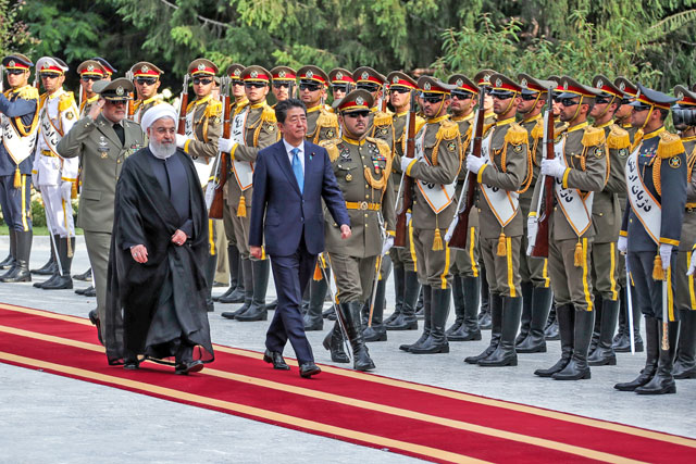   In this handout photo provided by the Iranian president’s website, Iranian President Hassan Rouhani walks with Japan's Prime Minister Shinzo Abe, during a welcome ceremony in Tehran, Iran, on Wednesday (Reuters photo)