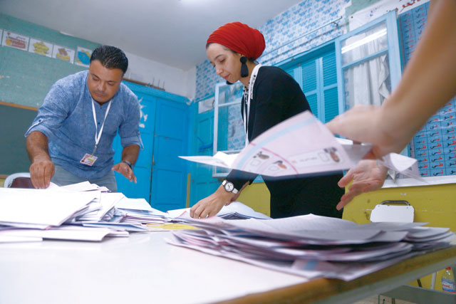 Tunisian volunteers count ballots at a polling station in Sousse, south of the capital Tunis, on Sunday (AFP photo)