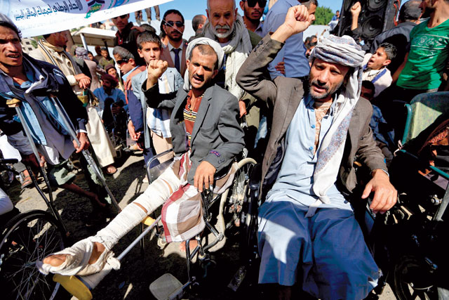 Disabled Yemenis demonstrate during a protest against air strikes the day before the international day of disabled persons, in front of United Nations' office in Sanaa, on Sunday (AFP photo)