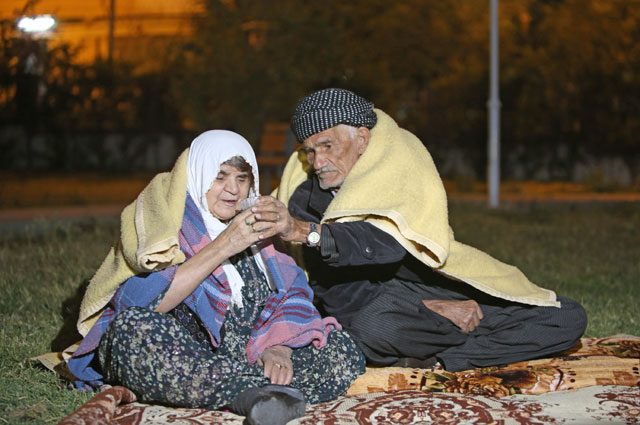 People sit outside as a precaution during the night at Darbandikhan district of Suleymaniyah after an earthquake measuring 7.3 on the Richter scale rocked northern Iraq and Iran on Monday, in Suleymaniyah, Iraq, on Wednesday (Anadolu Agency photo)