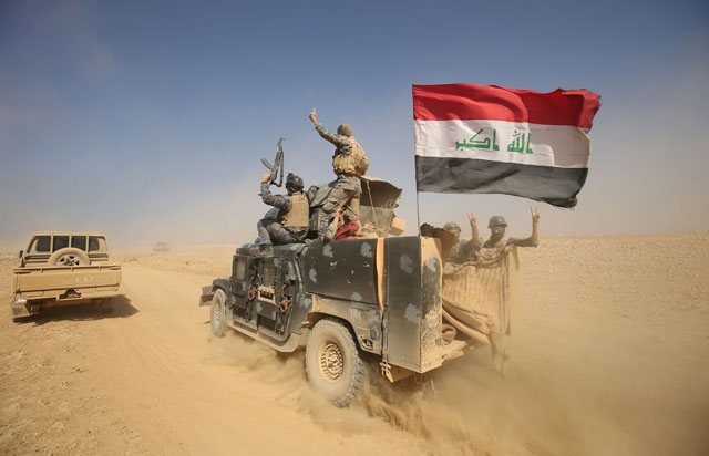 Iraqi forces deploy in the Bajwaniyah village, about 30km south of Mosul, on Tuesday after they liberated it from Daesh militants (AFP photo)