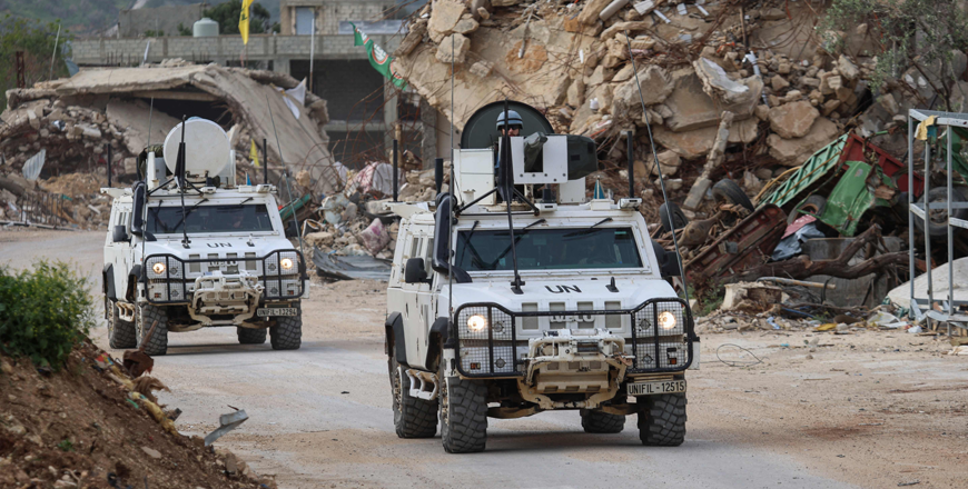 United Nations peacekeepers drive in vehicles of the UN Interim Force in Lebanon (UNIFIL) past destroyed buildings while patroling in Lebanon's southern village of Kfar Kila close to the border with Israel on April 6, 2025 (AFP photo)