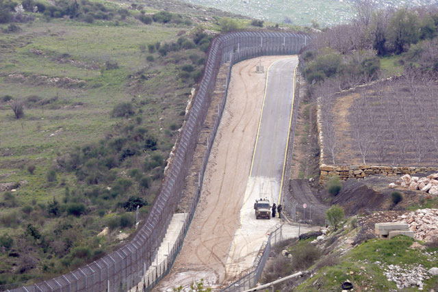 This photo taken on Wednesday from the village of Majdal Shams in the Israeli-annexed Golan Heights shows Israeli forces patrolling the border fence along the border with Syria (AFP photo)