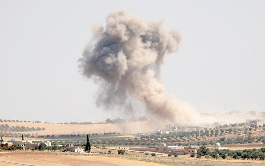 Smoke billows during bombardments in the area of Maar Hattat in Syria's northern Idlib province on Tuesday (AFP photo)