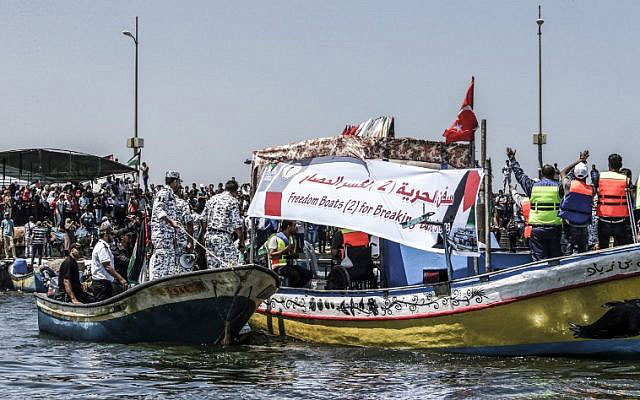 Activists escort a boat carrying Palestinians injured during confrontations along the Gaza security fence as it tries to break through Israel’s naval blockade from the Gaza City harbour on Sunday  (AFP photo)