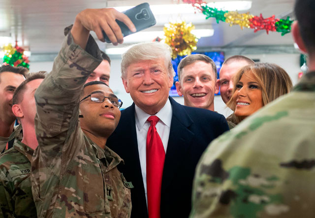 US President Donald Trump and First Lady Melania Trump greet members of the US military during an unannounced trip to Al Asad Airbase in Iraq on Wednesday (AFP photo)