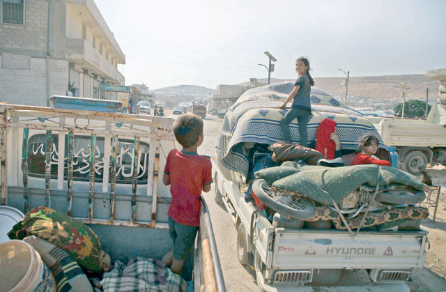 Displaced Syrians, who fled from their villages near the village of Jibala in the south of Idlib province, return home shortly before a truce fell apart between rebels and the government, on Sunday (AFP photo)