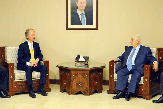   This handout photo released by the official Syrian Arab News Agency on Sunday shows Foreign Minister and  Deputy Prime Minister of Syria Walid Muallem meeting with United Nations Special Envoy to Syria Geir Pedersen in the Syrian capital Damascus (AFP photo)