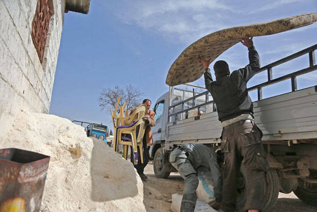 Syrians pack their belongings as they flee their home in the town of Utaya in the Syrian rebel enclave of Eastern Ghouta on Thursday (AFP photo)