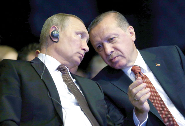 Turkish President Recep Tayyip Erdogan (right) talks with his Russian counterpart Vladimir Putin during the opening ceremony of the 23rd World Energy Congress in Istanbul, Turkey, on Monday (AFP photo)