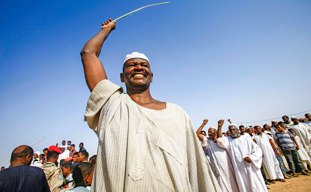   Supporters of the deputy head of Sudan's ruling Transitional Military Council and commander of the Rapid Support Forces paramilitaries dance as they greet him upon his arrival in the village of Qarri, about 90 kilometres north of Khartoum, on Saturday (AFP photo)