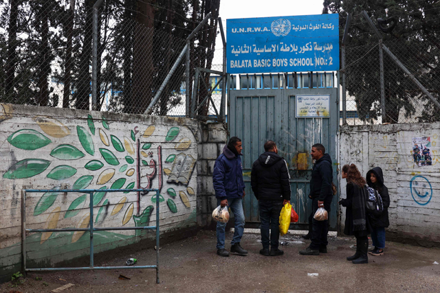 Palestinians stand outside a United Nations school in Balata camp, east of Nablus in the occupied West Bank, on February 6, 2025 (AFP photo)