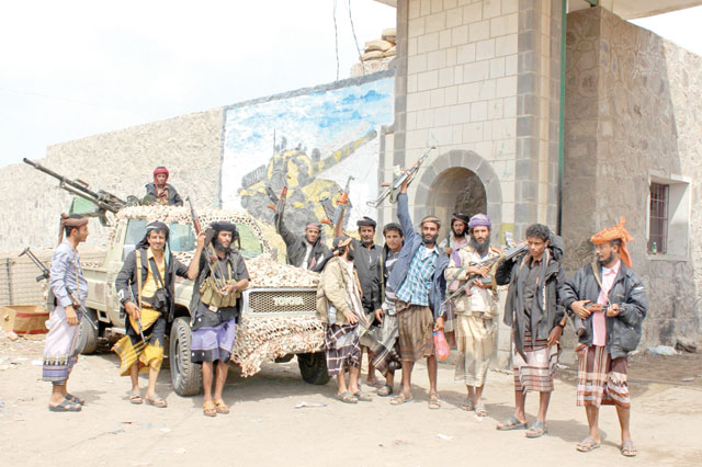 Fighters from the separatist Southern Transitional Council stand at the entrance of a military camp after they took control of the pro-government position in the Dar Saad district, in the north of Aden, on Wednesday (AFP photo)