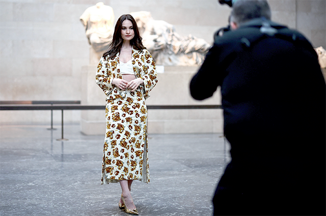 British actress Lily James poses in front of the Parthenon Marbles, also known as the Elgin Marbles, at the British Museum prior to Erdem Autumn/Winter 2024 collection fashion show during London Fashion Week in London on Saturday (AFP photo)