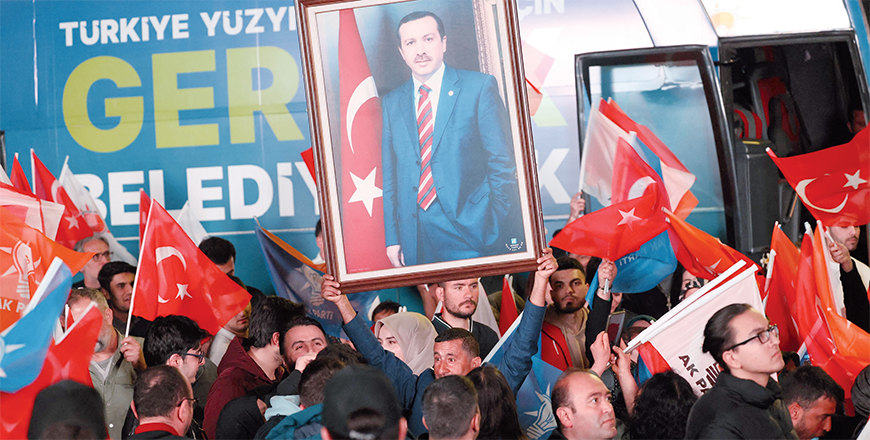 Supporters of Justice and Development (AK) Party cheer as Turkish President Recep Tayyip Erdogan delivers a speech after the Turkish local Municipal elections, at AK Party headquarters in Ankara on Monday (AFP photo)