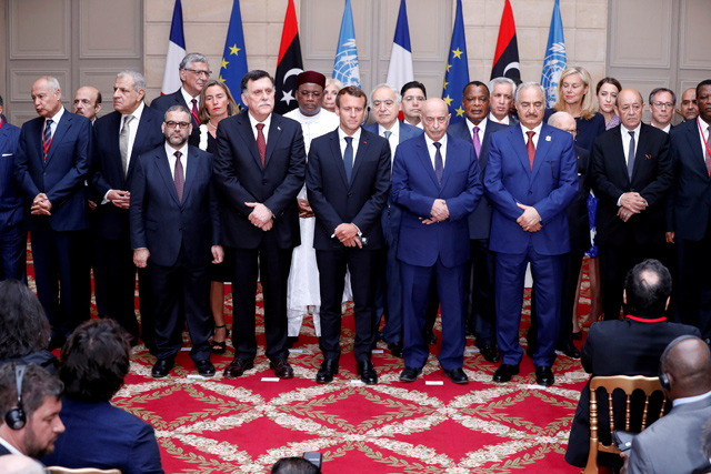 French President Emmanuel Macron, Libyan Prime Minister Fayez Al Sarraj, Khalifa Haftar, the military commander who dominates eastern Libya, and the participants of the International Conference on Libya listen to a verbal agreement between the various parties regarding the organisation of a democratic election this year at the Elysee Palace in Paris, France, May 29 (Reuters file photo)