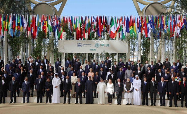 Participating world leaders and delegates pose for a family photo during the COP28 United Nations climate summit in Dubai on Friday (AFP photo)