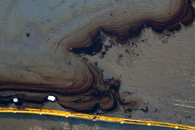 This aerial photo taken on October 3, 2021 shows oil containment booms in the water of the Talbert Marshlands area as oil from a spill at an offshore rig reaches the shore and sensitive wildlife habitats in Newport Beach, California (AFP photo)