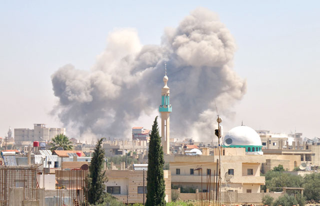 Smoke rises in the rebel-held town of Nawa, about 30 kilometres north of Daraa in southern Syria on Wednesday, during air strikes by Syrian regime forces  (AFP photo)