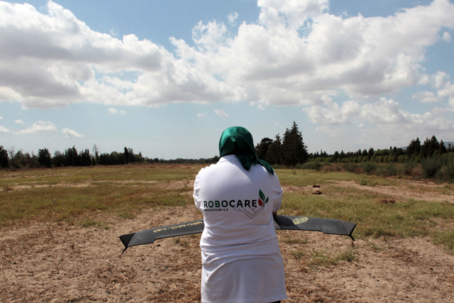Imen Hibri, the founder of RoboCare, prepares to fly a drone over an agricultural domain, to scan the trees from the air and assess their hydration levels, soil quality and overall health, to prevent irreversible damage, in the region of Nabeul, southwest of Tunis on August 30 (AFP photo)