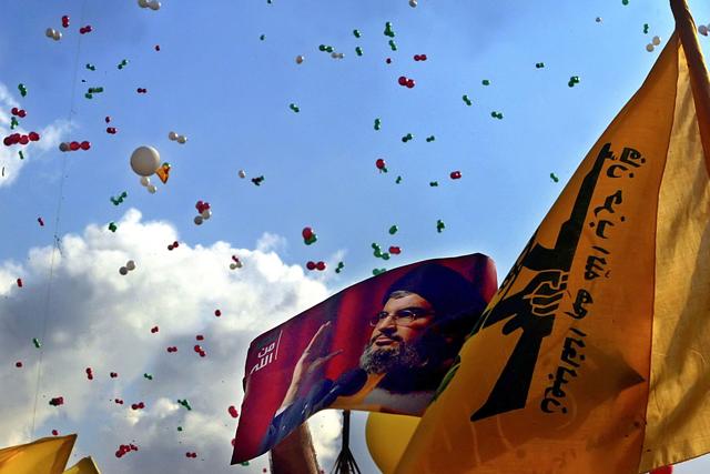 Balloons are flown over a poster of Hizbollah chief Hassan Nasrallah at a massive rally in a southern suburbs of Beirut, on September 22, 2006 (AFP photo)