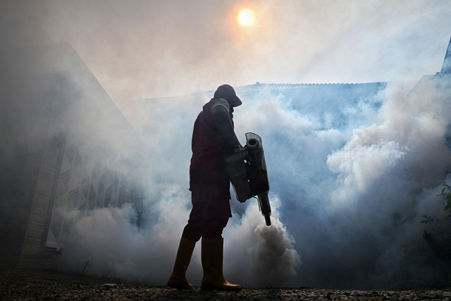 A worker dispenses insecticide with a fogging machine to kill mosquitos spreading dengue fever in Banda Aceh on Tuesday (AFP photo)