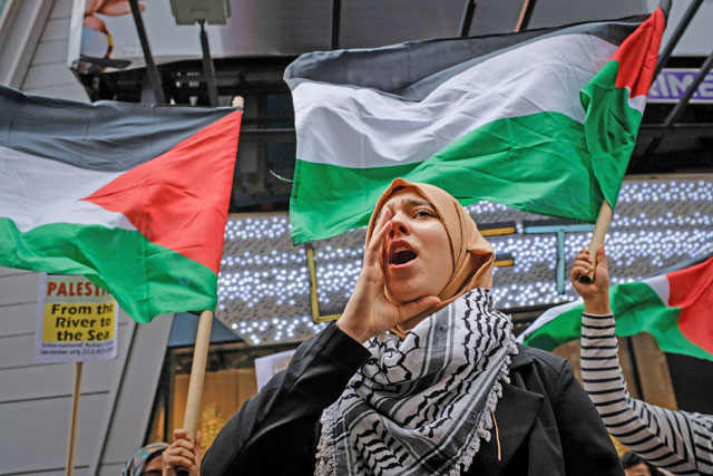 Members of the Palestinian community, fellow Muslims and their supporters rally in support of the Palestinian people in the wake of the recent killings in the Gaza Strip, during a rally in Times Square, on Friday, in New York City (AFP photo)