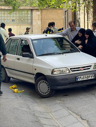 A photo shows two women mourning next to the body of Iranian Revolutionary Guards colonel Sayyad Khodai, after he was shot dead, in his car in the Iranian capital Tehran on Sunday (AFP photo)