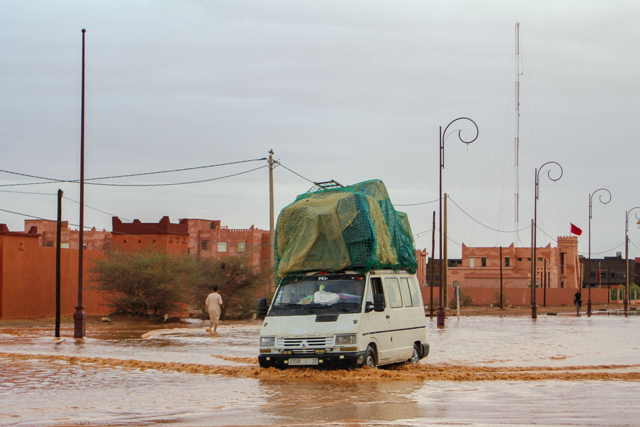 A car drives through a flooded street after flooding in Morocco's region of Zagora on september 7, 2024 (AFP photo)