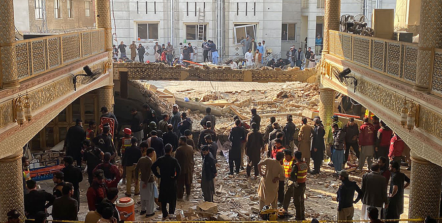 Security officials inspect the site of a mosque blast inside the police headquarters in Peshawar on Monday (AFP photo)