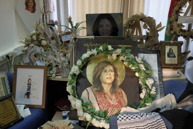 Pictures and other objects are displayed in memory of slain journalist Shireen Abu Akleh, in the room that used to be her office at Al Jazeera news channel, in the West Bank city of Ramallah, on Tuesday (AFP photo)